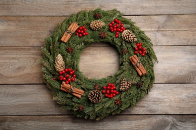 Photo of Beautiful Christmas wreath on wooden background, top view