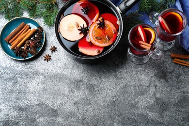 Delicious mulled wine and ingredients on grey table, flat lay. Space for text Photo of Delicious mulled wine and ingredients on grey table, flat lay. Space for text