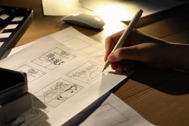 Woman drawing cartoon sketches at workplace, closeup. Pre-production process Photo of Woman drawing cartoon sketches at workplace, closeup. Pre-production process