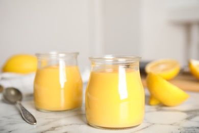 Delicious lemon curd on white marble table Photo of Delicious lemon curd on white marble table