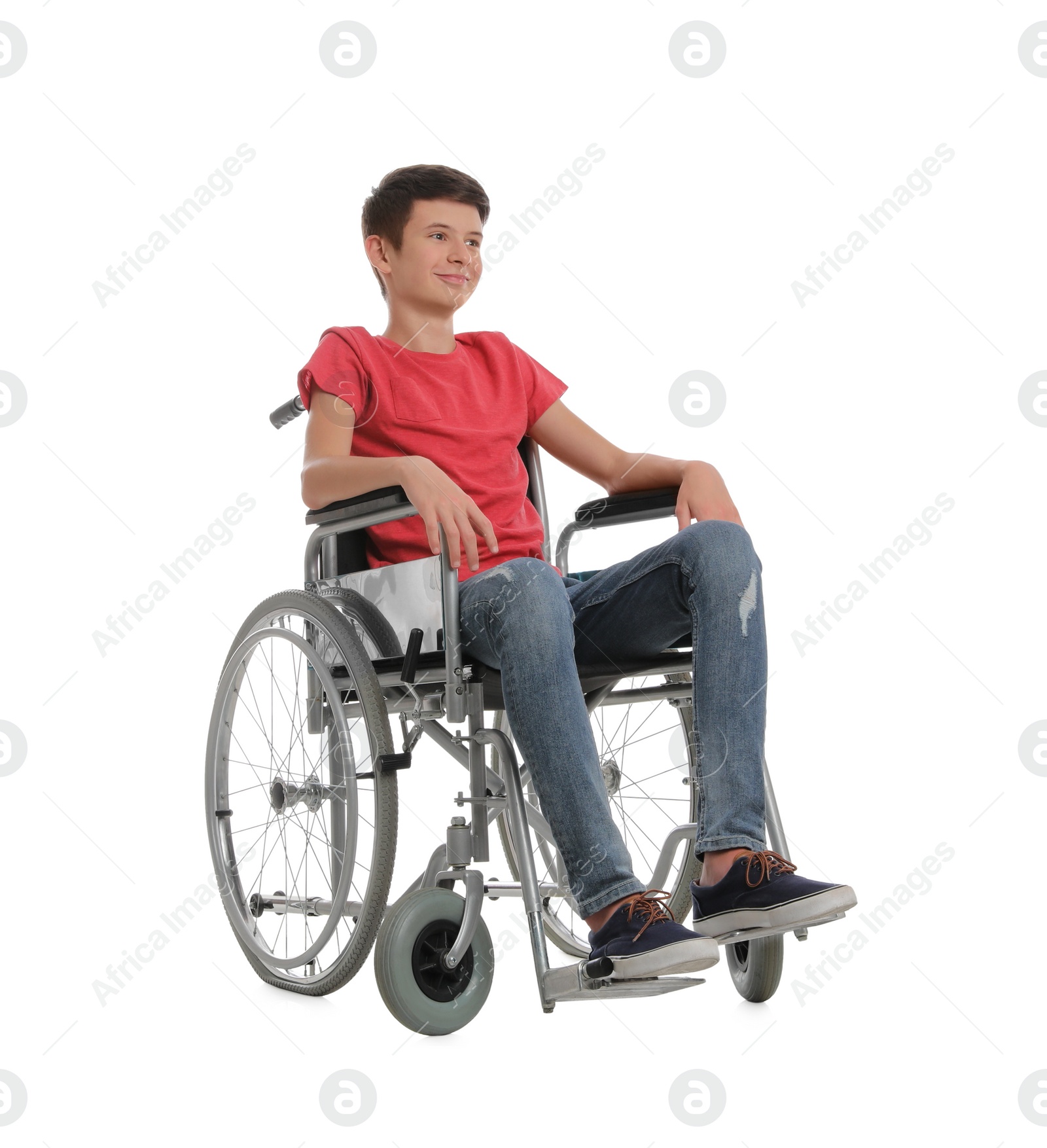 Teen boy in wheelchair on white background Photo of Teen boy in wheelchair on white background