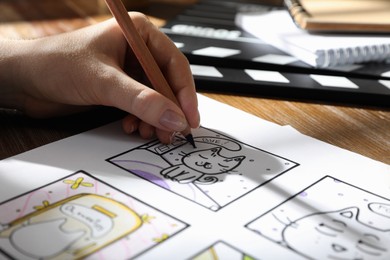 Woman drawing cartoon sketch at workplace, closeup. Pre-production process Photo of Woman drawing cartoon sketch at workplace, closeup. Pre-production process