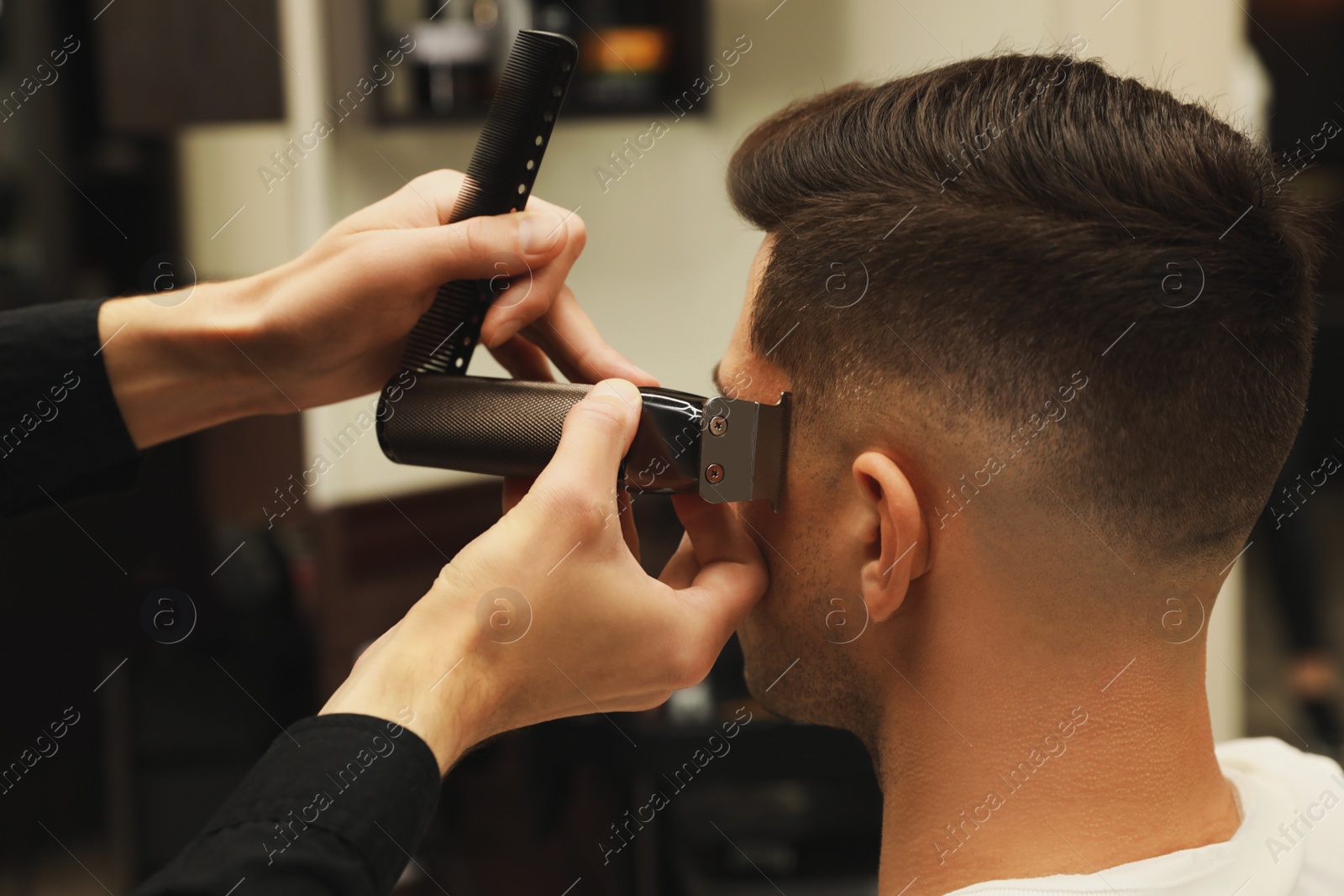 Professional hairdresser making stylish haircut in salon, closeup Photo of Professional hairdresser making stylish haircut in salon, closeup