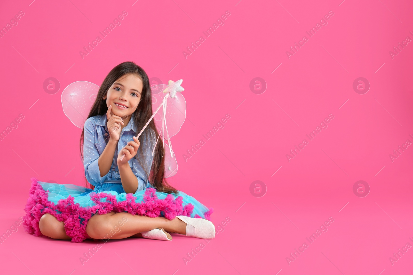 Cute little girl in fairy costume with wings and magic wand on pink background. Space for text Photo of Cute little girl in fairy costume with wings and magic wand on pink background. Space for text