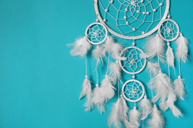 Beautiful dream catcher hanging on light blue background. Space for text Photo of Beautiful dream catcher hanging on light blue background. Space for text