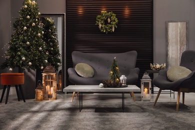 Elegant living room interior with comfortable sofa and Christmas decor Photo of Elegant living room interior with comfortable sofa and Christmas decor