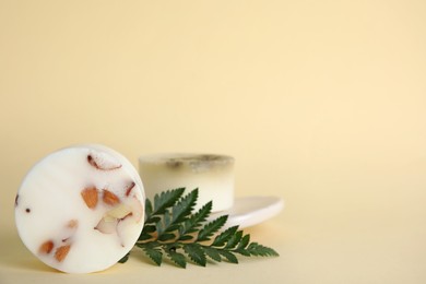 Soap bars and green leaf on beige background, space for text. Eco friendly personal care product Photo of Soap bars and green leaf on beige background, space for text. Eco friendly personal care product