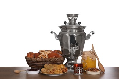 Traditional Russian samovar with treats on wooden table against white background Photo of Traditional Russian samovar with treats on wooden table against white background