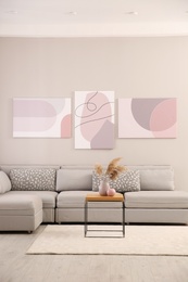 Stylish living room interior with big comfortable sofa and pictures Photo of Stylish living room interior with big comfortable sofa and pictures