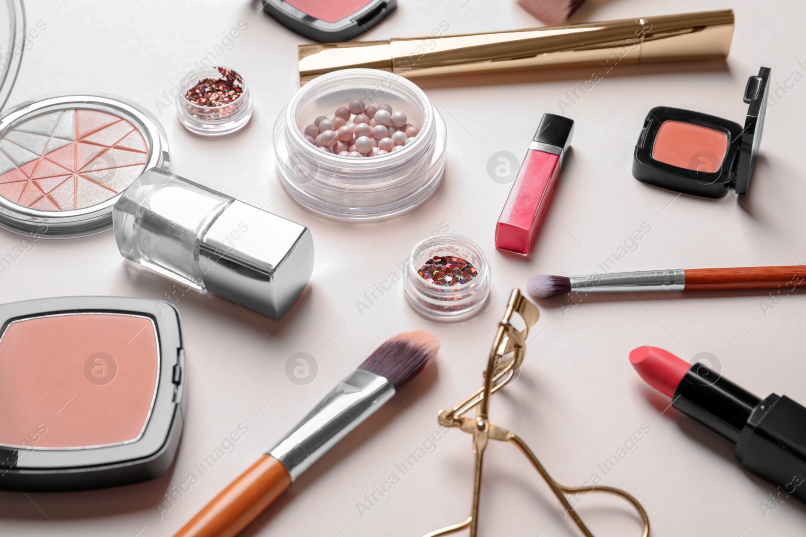 Decorative cosmetics and tools of professional makeup artist on color background Photo of Decorative cosmetics and tools of professional makeup artist on color background