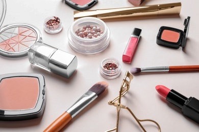 Decorative cosmetics and tools of professional makeup artist on color background Photo of Decorative cosmetics and tools of professional makeup artist on color background
