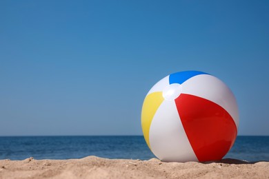 Colorful inflatable ball on sandy beach. Space for text Photo of Colorful inflatable ball on sandy beach. Space for text