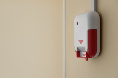 Fire alarm switch on light wall indoors. Space for text Photo of Fire alarm switch on light wall indoors. Space for text