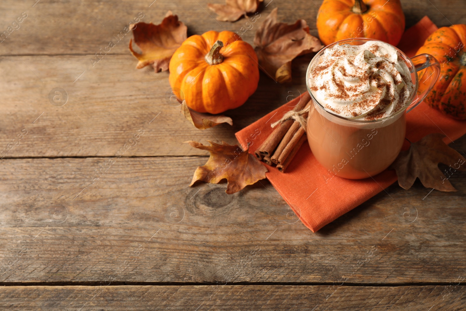 Delicious pumpkin latte on wooden table. Space for text Photo of Delicious pumpkin latte on wooden table. Space for text