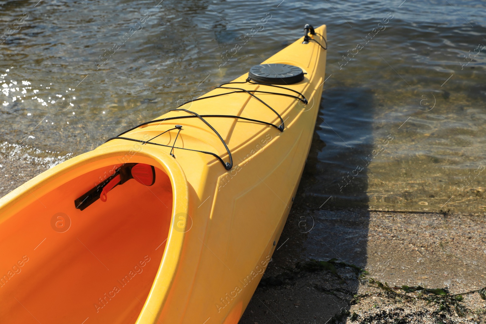 Yellow kayak on beach near river, closeup. Summer camp activity Photo of Yellow kayak on beach near river, closeup. Summer camp activity