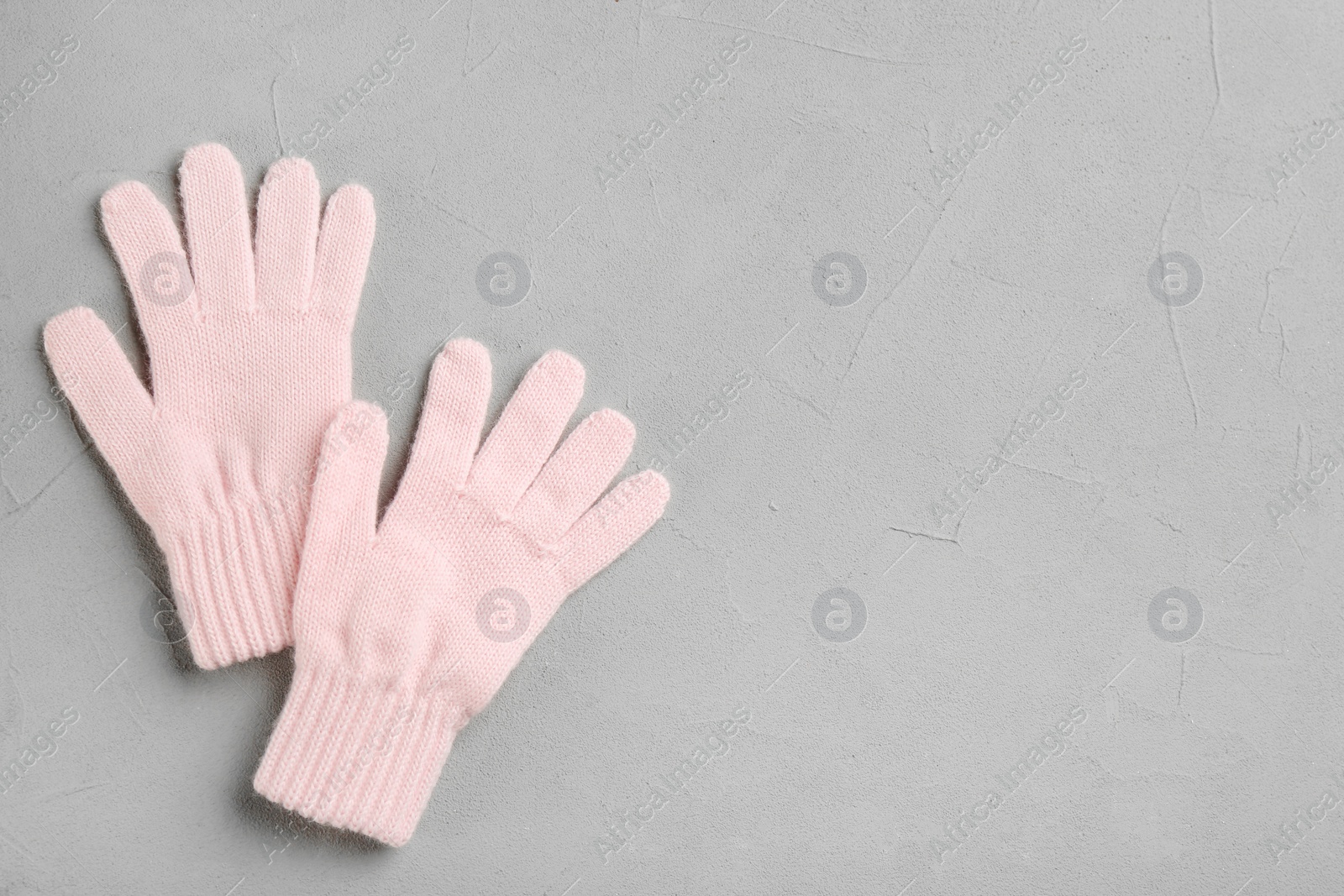 Stylish gloves on grey background, flat lay. Space for text Photo of Stylish gloves on grey background, flat lay. Space for text