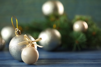 Beautiful Christmas balls on table against blurred background. Space for text Photo of Beautiful Christmas balls on table against blurred background. Space for text