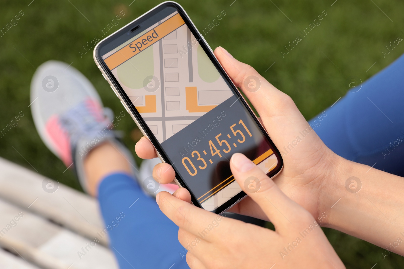 Young woman using fitness app on smartphone outdoors, closeup Photo of Young woman using fitness app on smartphone outdoors, closeup
