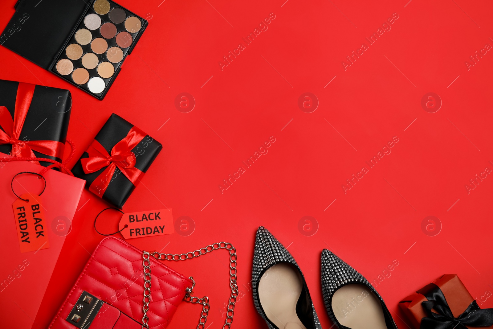 Gift boxes, cosmetics, shoes, stylish women's accessories and space for text on red background, flat lay. Black Friday sale Photo of Gift boxes, cosmetics, shoes, stylish women's accessories and space for text on red background, flat lay. Black Friday sale