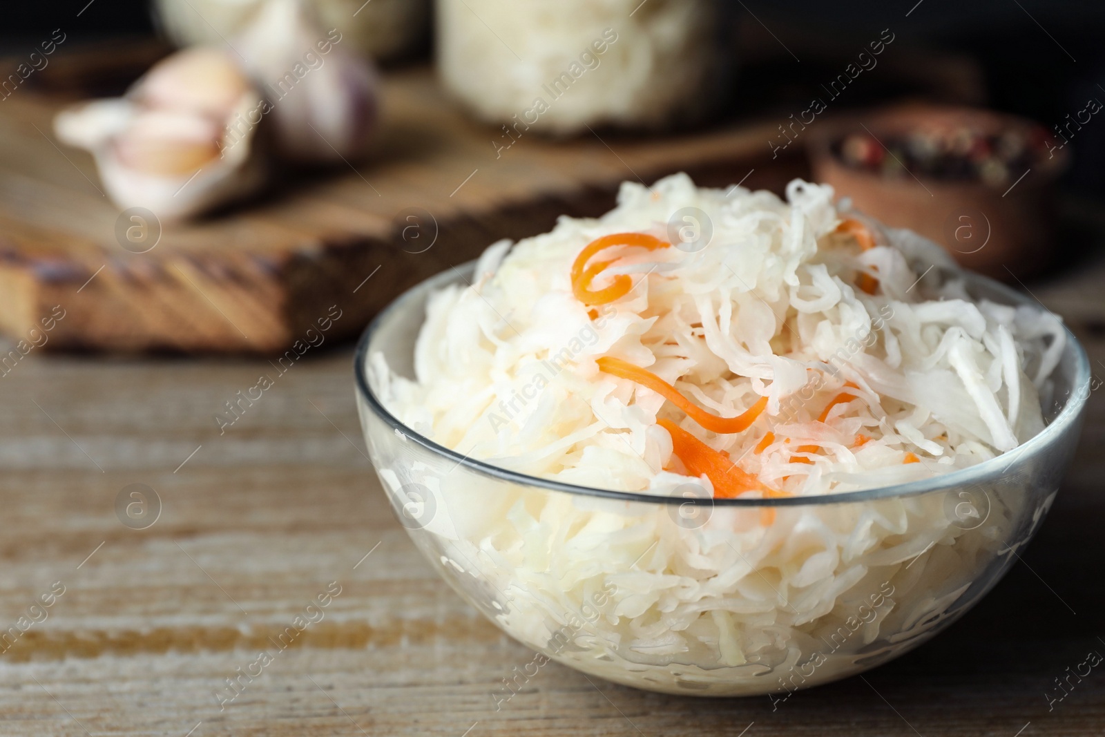 Tasty fermented cabbage on wooden table, closeup Photo of Tasty fermented cabbage on wooden table, closeup