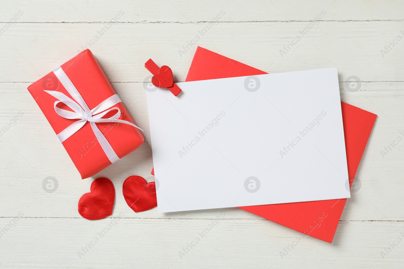 Flat lay composition with blank card on white wooden background, space for text. Valentine's Day celebration Photo of Flat lay composition with blank card on white wooden background, space for text. Valentine's Day celebration