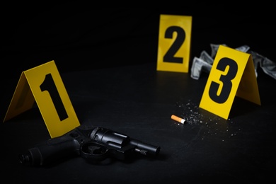 Photo of Crime scene markers and evidences on black background