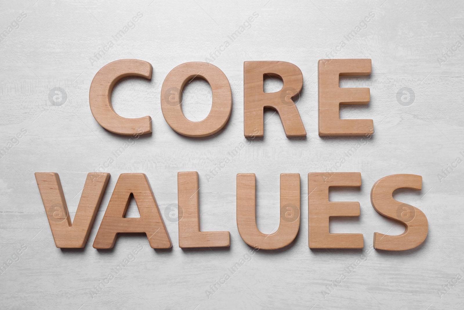 Phrase CORE VALUES made of wooden letters on white background, flat lay Photo of Phrase CORE VALUES made of wooden letters on white background, flat lay
