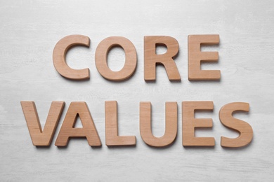 Phrase CORE VALUES made of wooden letters on white background, flat lay Photo of Phrase CORE VALUES made of wooden letters on white background, flat lay