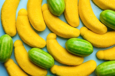 Many delicious candies on light blue background, flat lay Photo of Many delicious candies on light blue background, flat lay