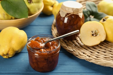 Delicious quince jam and fruits on blue wooden table, closeup Photo of Delicious quince jam and fruits on blue wooden table, closeup