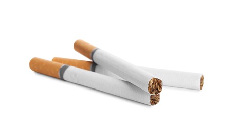 Cigarettes with orange filters isolated on white Photo of Cigarettes with orange filters isolated on white