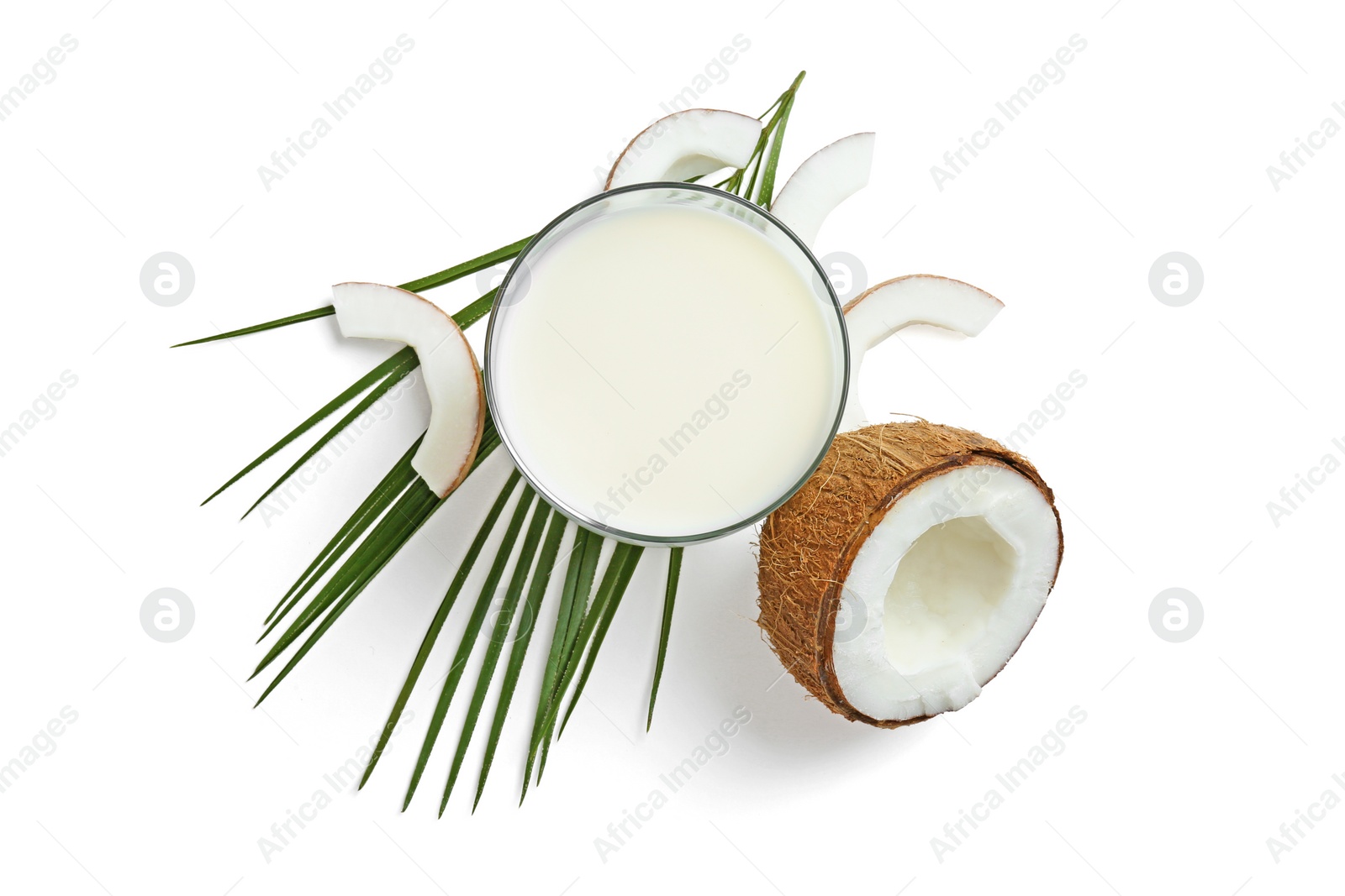 Glass of coconut milk and nuts on white background, top view Photo of Glass of coconut milk and nuts on white background, top view