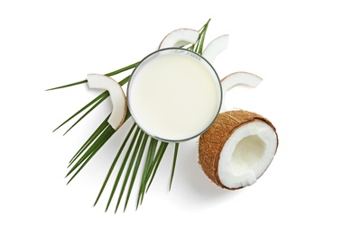 Glass of coconut milk and nuts on white background, top view Photo of Glass of coconut milk and nuts on white background, top view