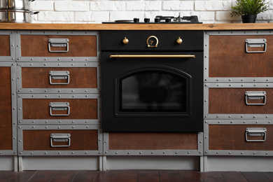 Photo of New modern oven in stylish kitchen. Cooking appliance