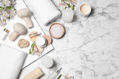 Flat lay composition with spa essentials on white marble background. Space for text Photo of Flat lay composition with spa essentials on white marble background. Space for text
