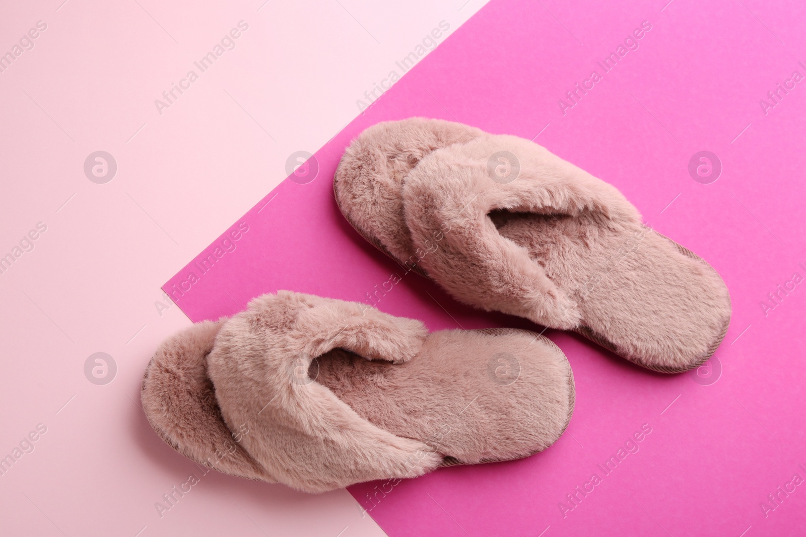 Pair of stylish soft slippers on color background, flat lay Photo of Pair of stylish soft slippers on color background, flat lay