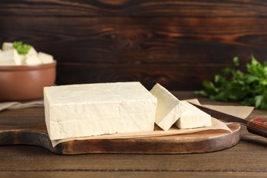 Piece of delicious tofu on wooden table Photo of Piece of delicious tofu on wooden table