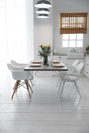 Photo of Beautiful dining room interior with new stylish furniture