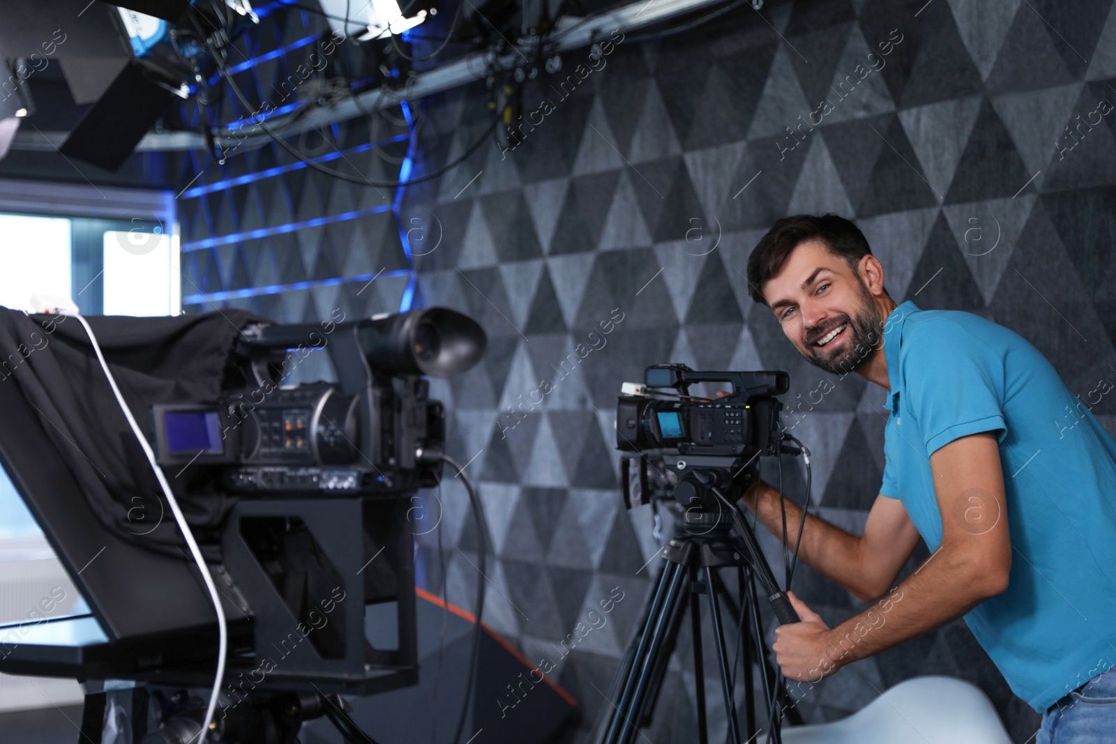 Professional video camera operator working in studio Photo of Professional video camera operator working in studio