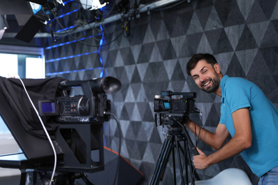 Professional video camera operator working in studio Photo of Professional video camera operator working in studio
