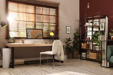 Light room interior with comfortable workplace near window Photo of Light room interior with comfortable workplace near window