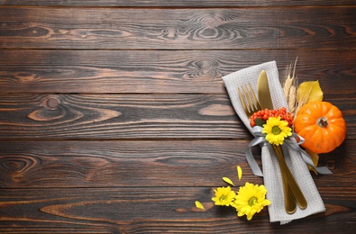 Cutlery and autumn decor on wooden table, flat lay with space for text. Thanksgiving Day celebration Photo of Cutlery and autumn decor on wooden table, flat lay with space for text. Thanksgiving Day celebration