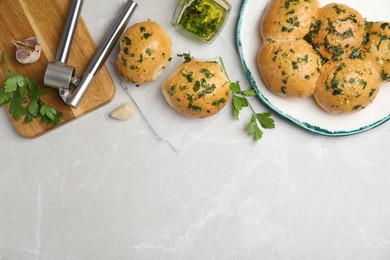 Traditional Ukrainian bread (Pampushky) with garlic on light grey marble table, flat lay. Space for text Photo of Traditional Ukrainian bread (Pampushky) with garlic on light grey marble table, flat lay. Space for text