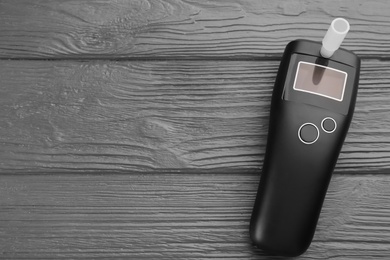 Modern breathalyzer on grey wooden background, top view. Space for text Photo of Modern breathalyzer on grey wooden background, top view. Space for text