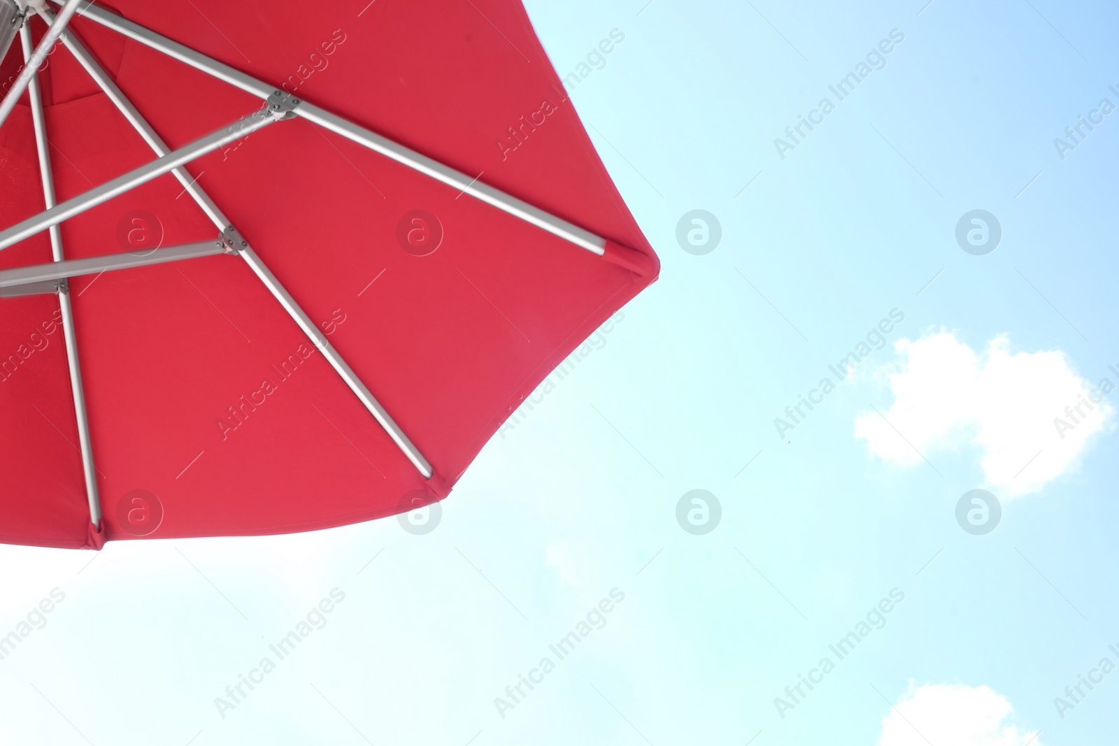 View of red umbrella and blue sky on sunny day Photo of View of red umbrella and blue sky on sunny day