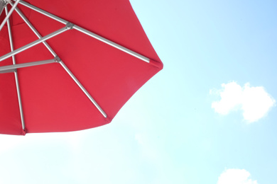 Photo of View of red umbrella and blue sky on sunny day