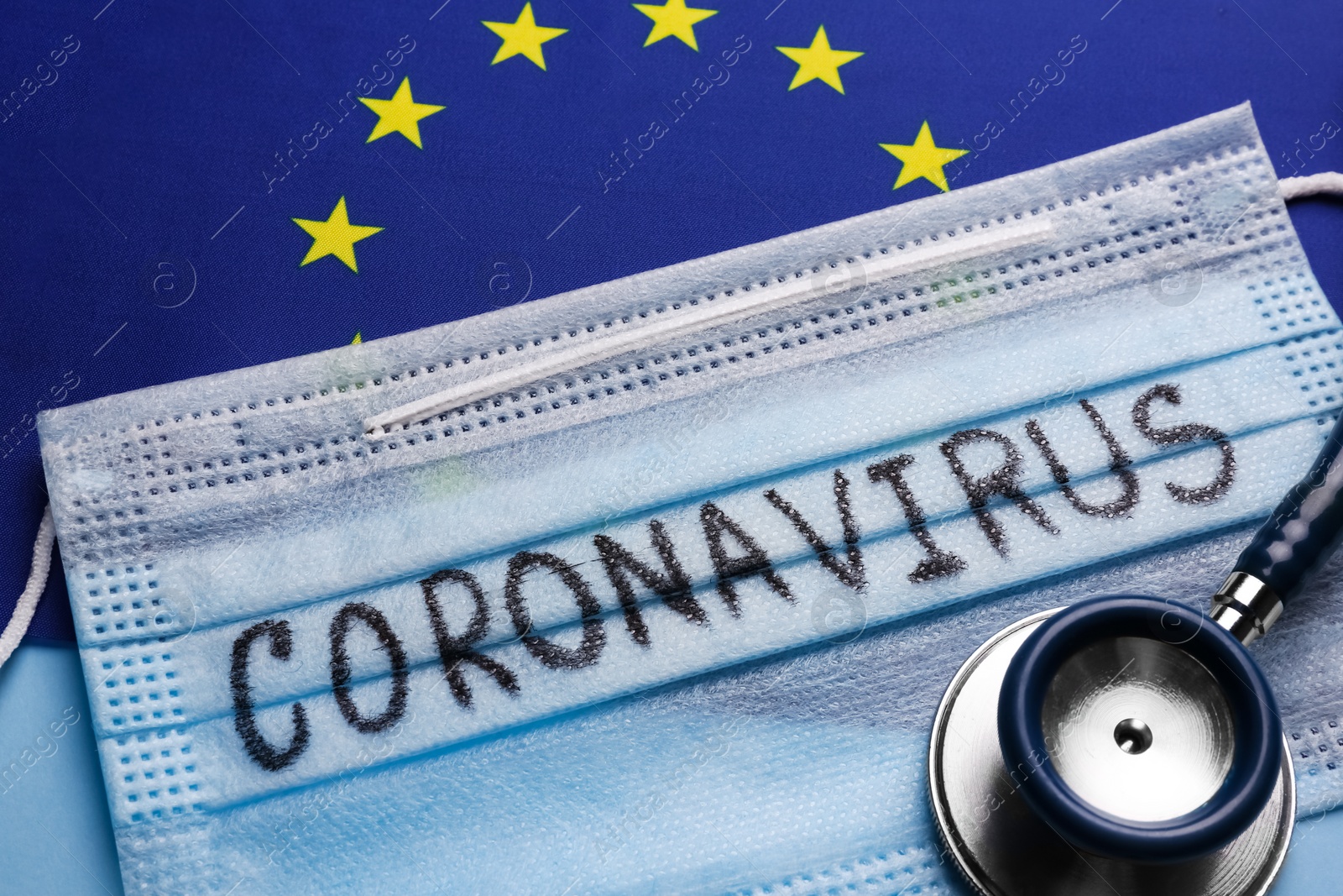 European Union flag, protective mask and stethoscope on light blue background, closeup. Coronavirus outbreak Photo of European Union flag, protective mask and stethoscope on light blue background, closeup. Coronavirus outbreak