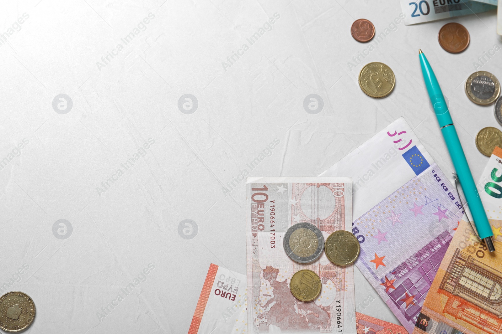 Money and pen on light table, flat lay. Space for text Image of Money and pen on light table, flat lay. Space for text