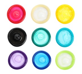 Set with different unpacked condoms on white background, top view Image of Set with different unpacked condoms on white background, top view