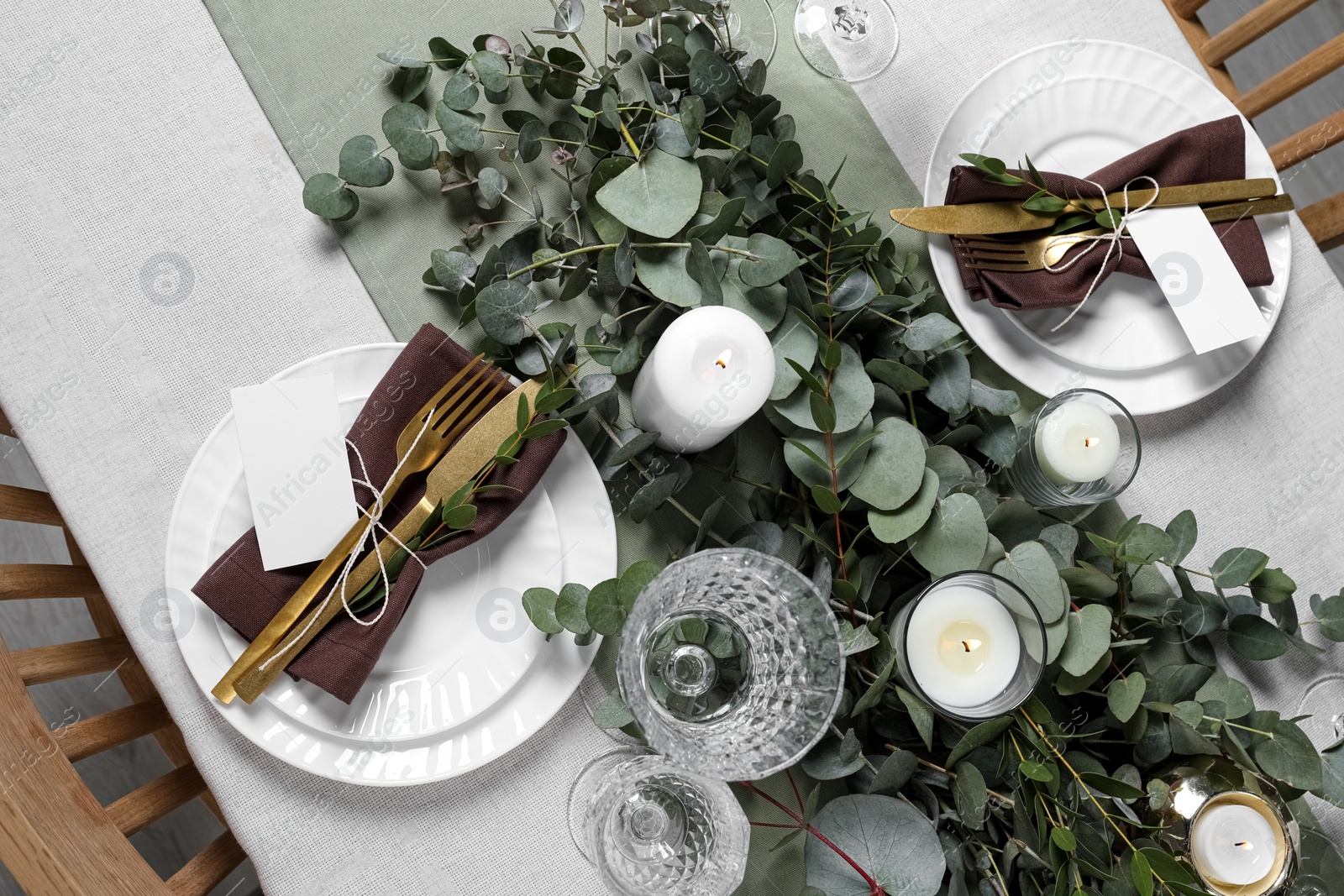 Luxury table setting with beautiful decor and blank cards. Festive dinner Photo of Luxury table setting with beautiful decor and blank cards. Festive dinner